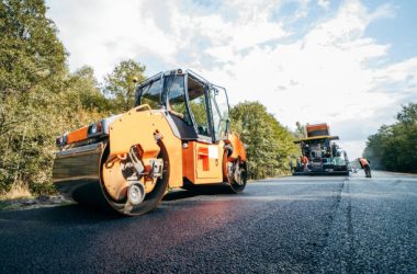 Road service repairs the highway asphalt rollers compactor compacting new asphalt pavement. Road service repairs the highway